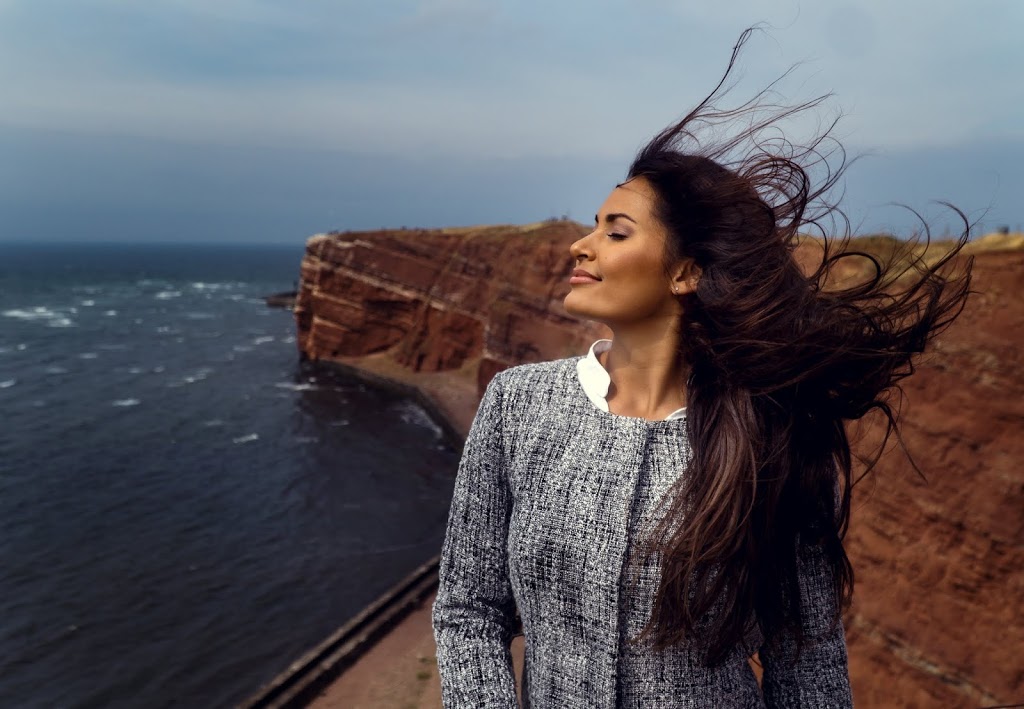 lady by ocean with wind blowing hair