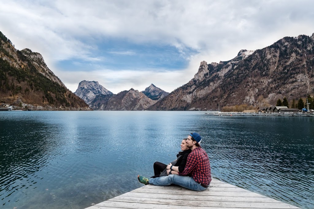 man and woman in recovery cuddling by lake
